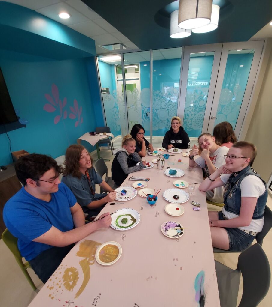 Group of youth doing arts and crafts at a long table