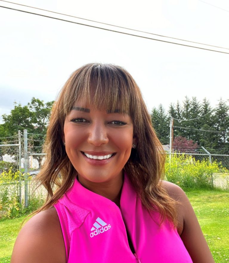 Picture of Lisa Prokopenko wearing a bright pink tank top and smiling.